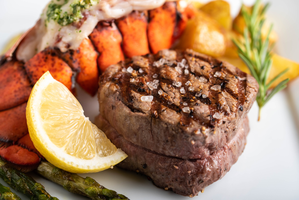 filet and lobster surf and turf meal on a marble background