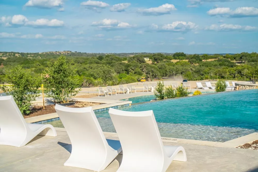lounge chairs by the resort swimming pool at Firefly Resort in Fredericksburg