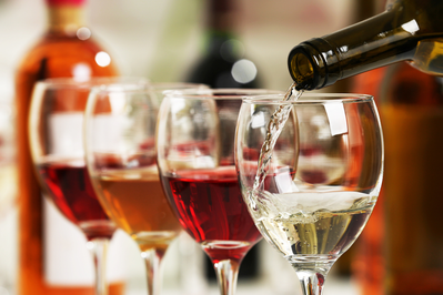 assortment of wines being poured into glasses 