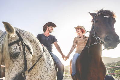 couple riding horses together