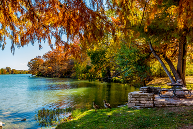 picnic table by water in fall texas hill country
